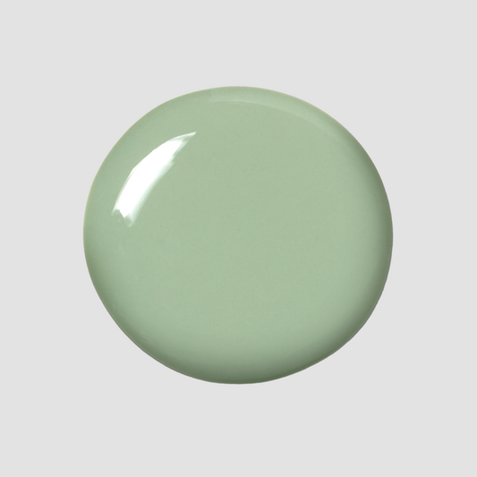 Hand with Cardigan painted on nails holding mini lacquer bottle