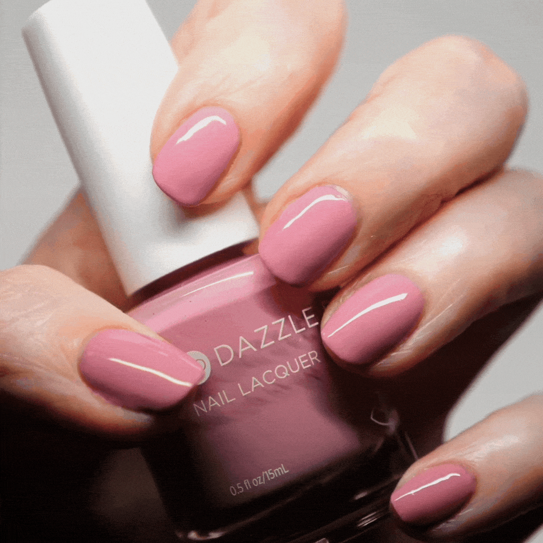 Hand with Picking Peonies painted on nails holding lacquer bottle