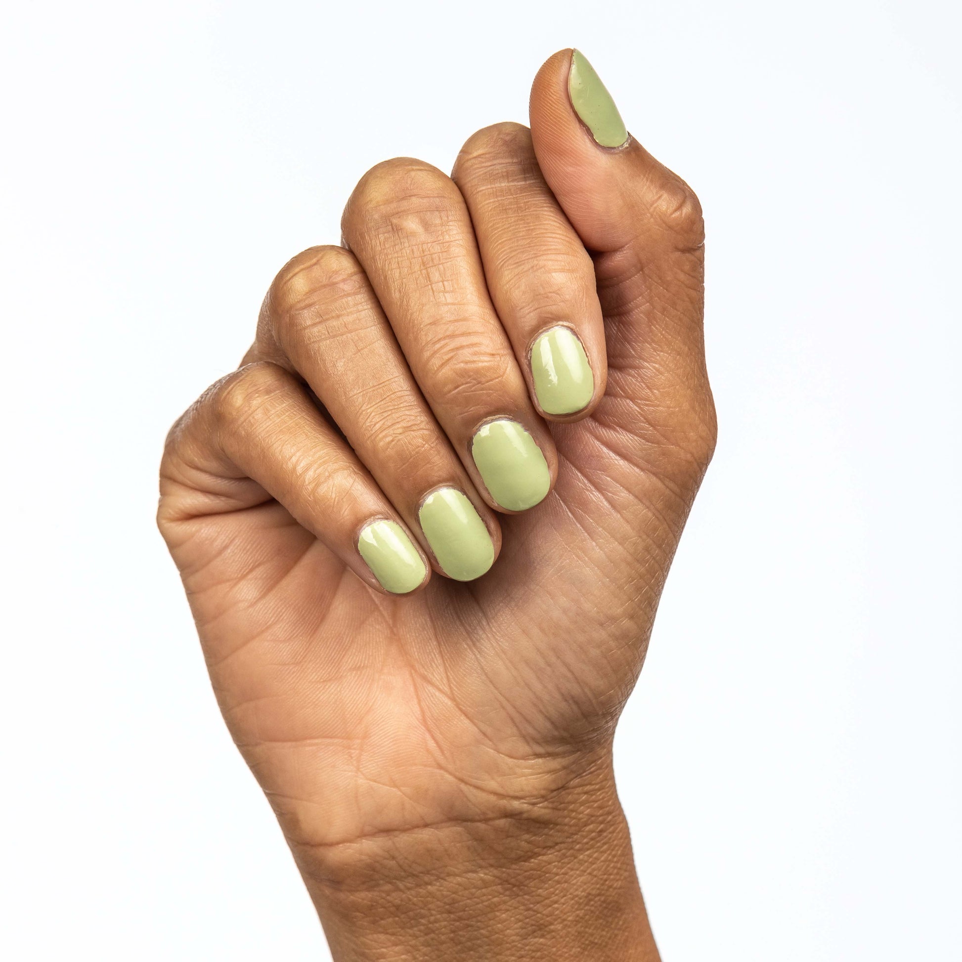 Hand with Pistachio painted on nails