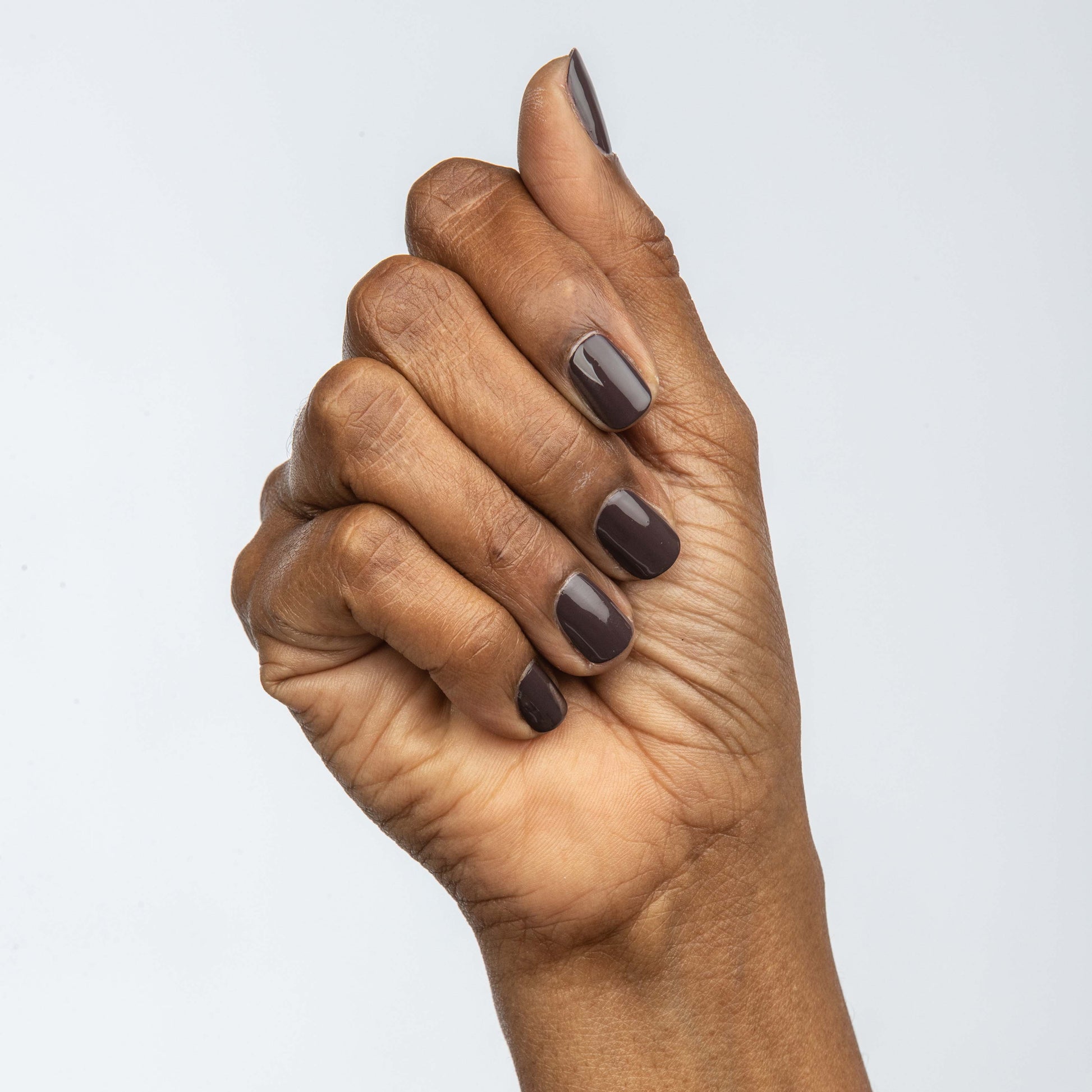 Hand with Rum Raisin painted on nails