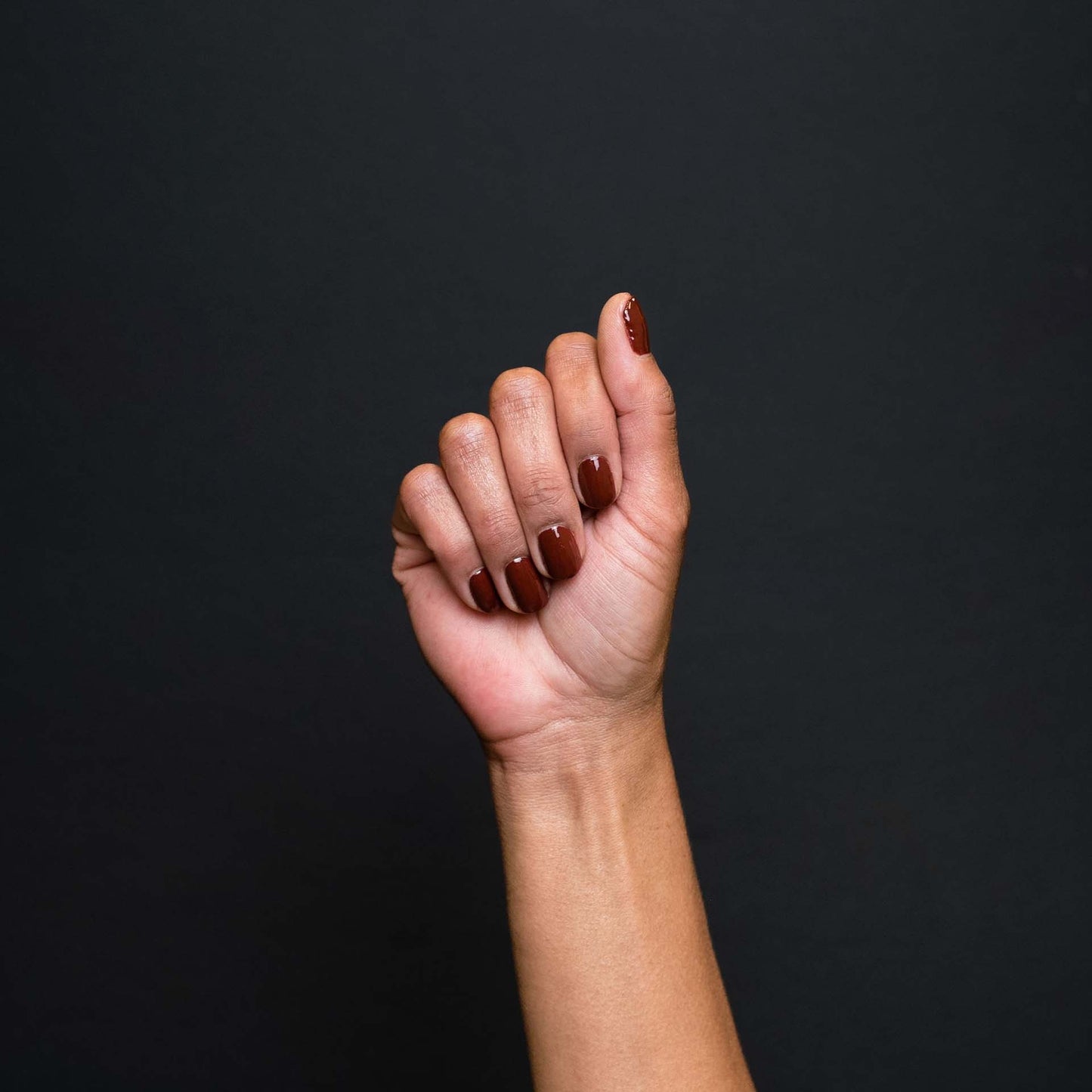 Hand with Siena painted on nails